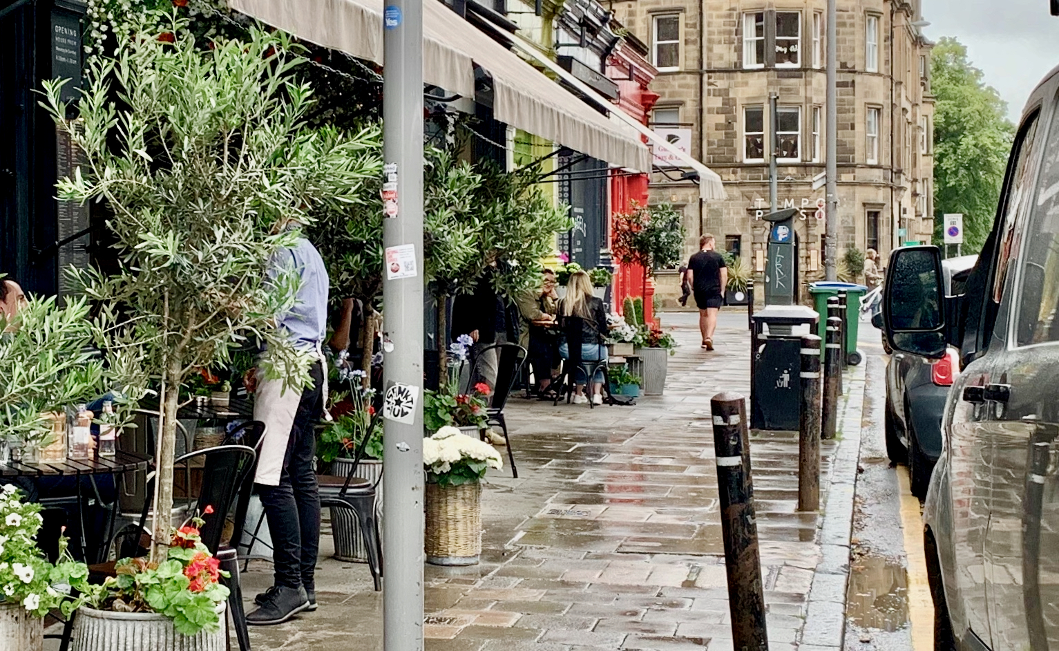View of pavement outside Montpeliers cafe/bar in Bruntsfield showing effect of street furniture in impeding pedestrians.
